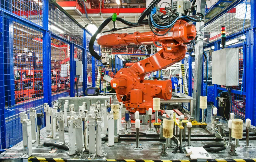 Industrial robot arm in a caged automotive production cell
